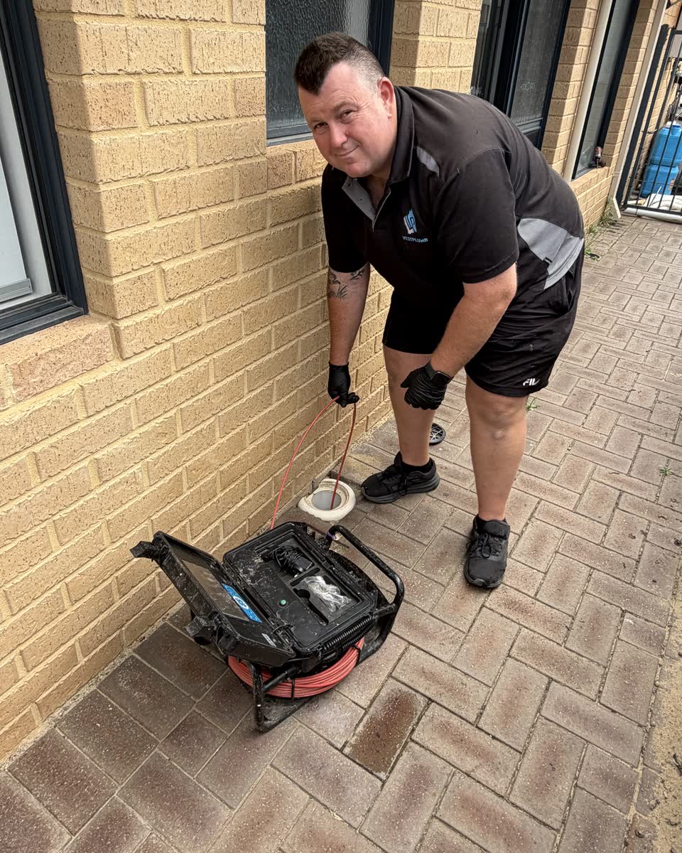 Brent at an outdoor drain with the jetter hose