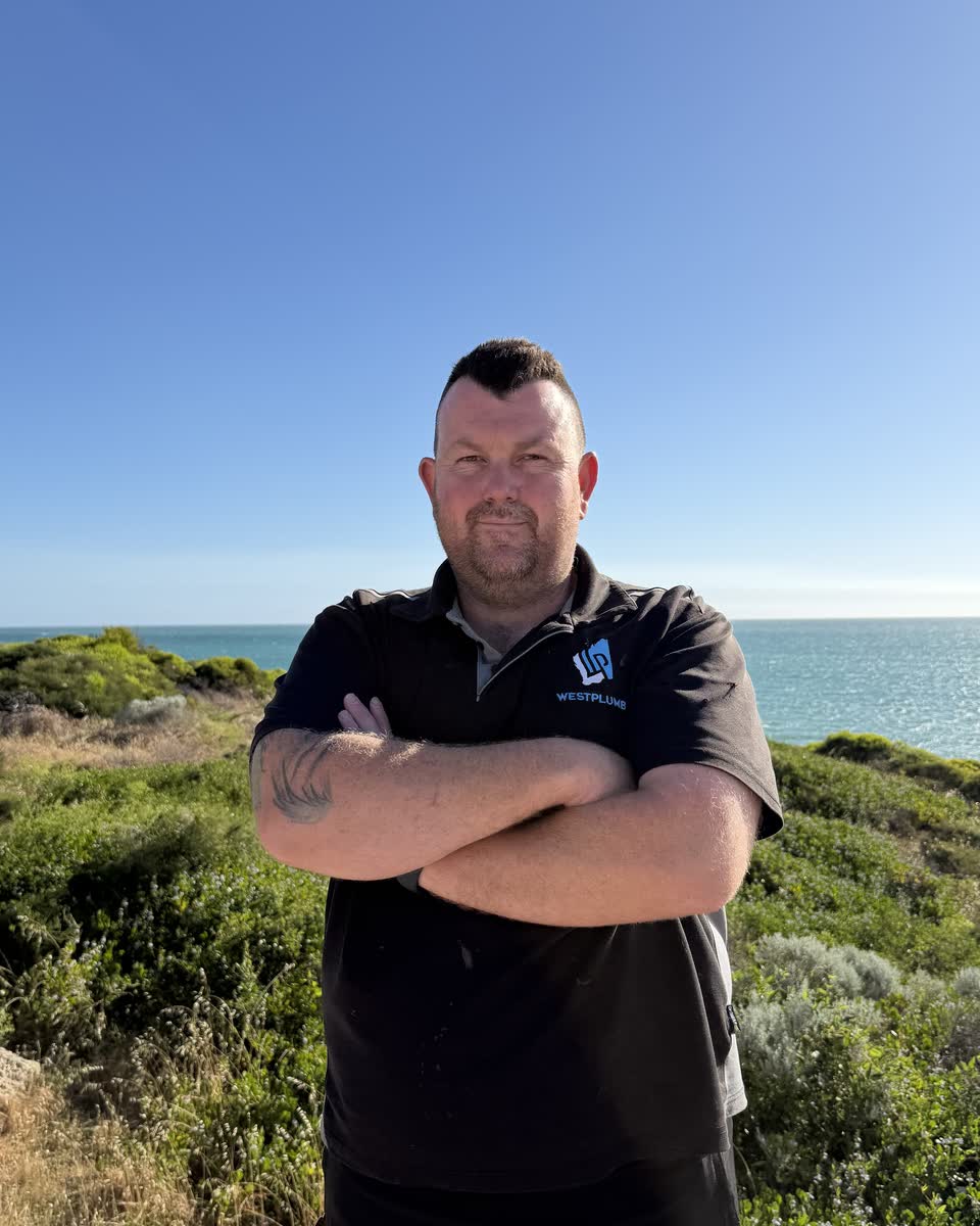 Brent, arms crossed, on the Perth coast