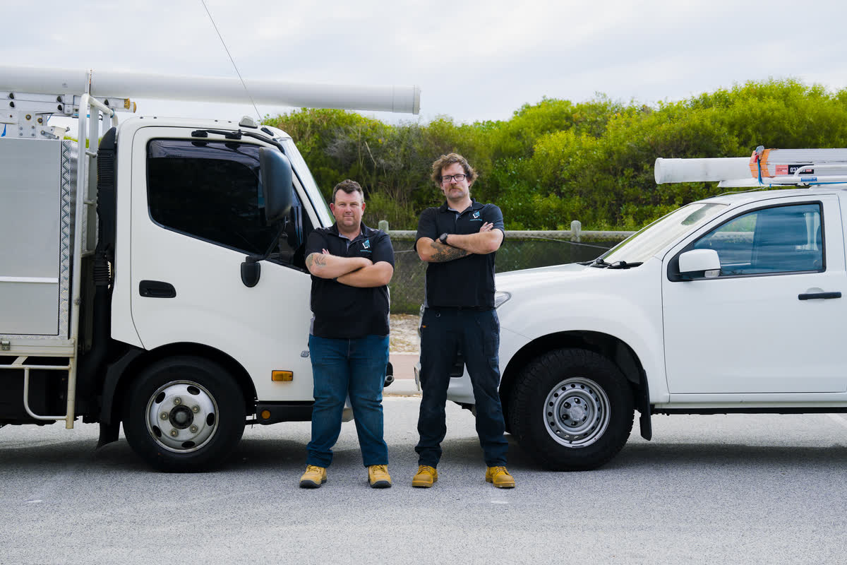 Two of the Westplumb team between the truck and the ute