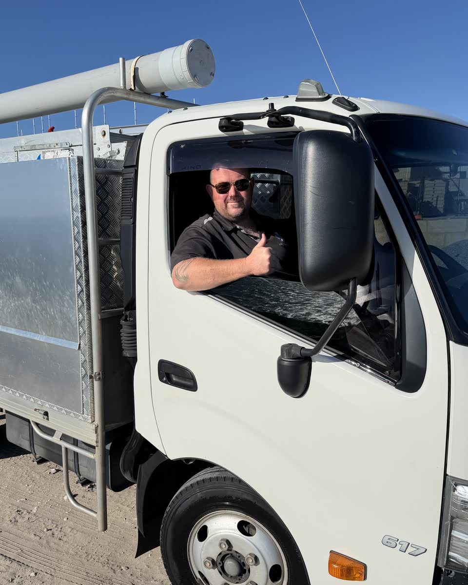 Brent in the cab of the Westplumb truck