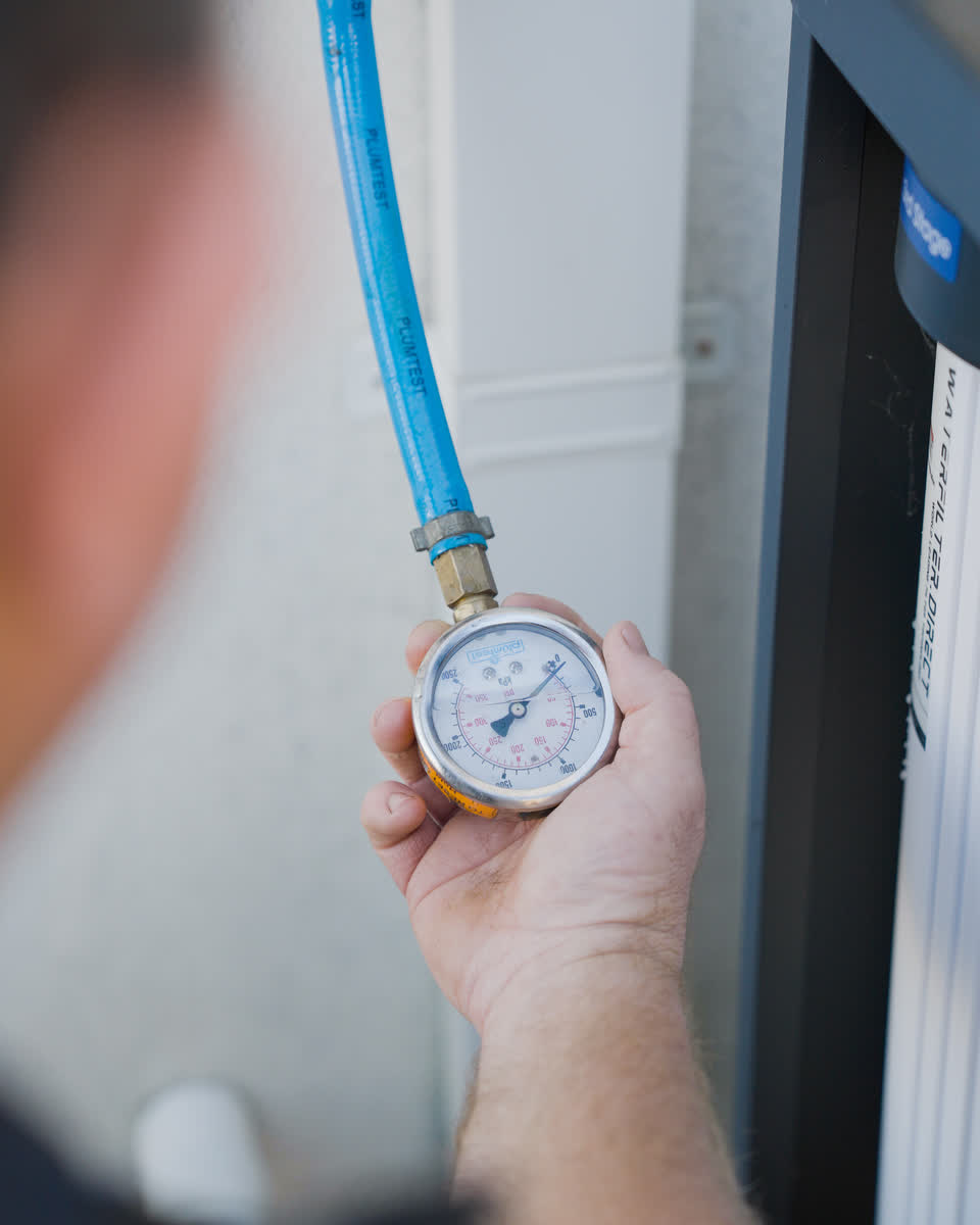 A pressure gauge fitted to an outside tap