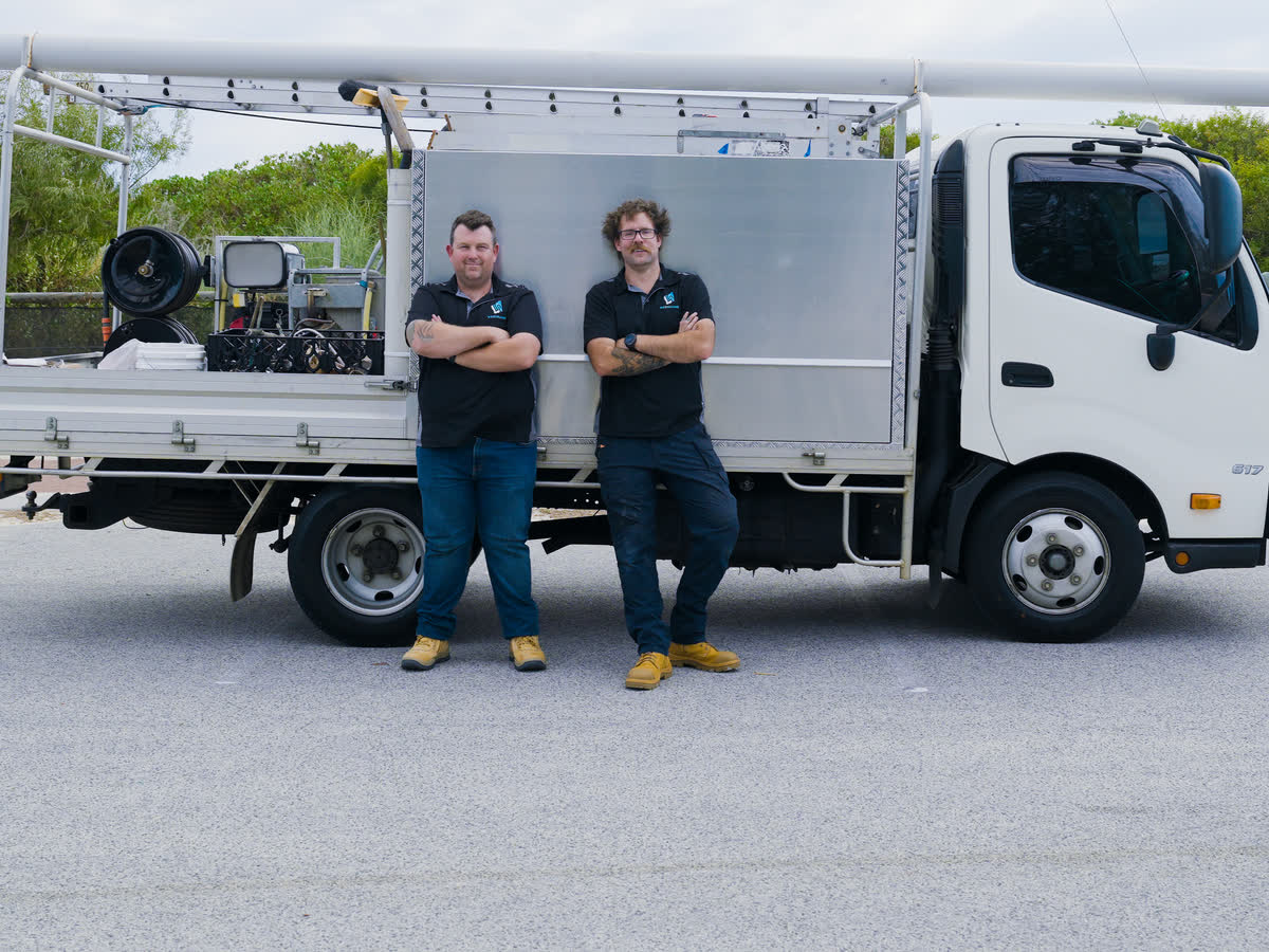 Brent and a Westplumb plumber in front of the work truck